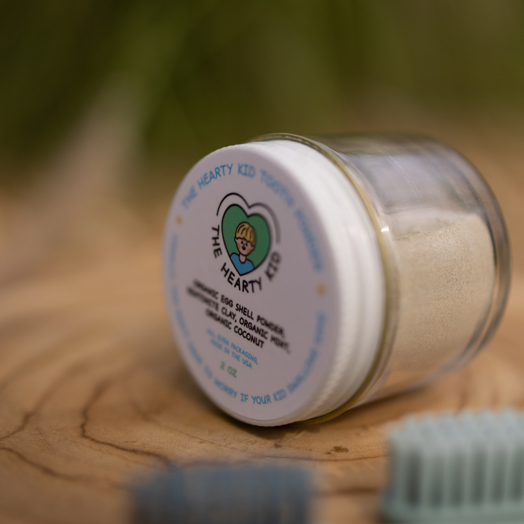 Close detail of The Hearty Kid Organic Kid Tooth Powder jar